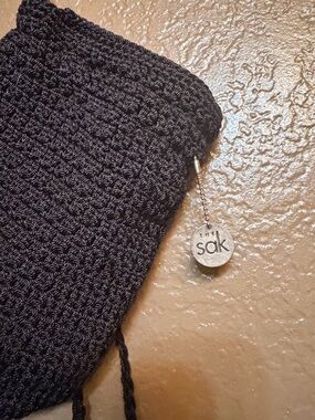 The Sak Black Crocheted crossbody Bag with Signature Charm